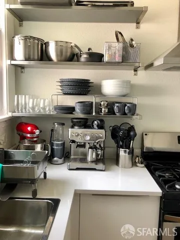 a kitchen with a stove a microwave and cabinets