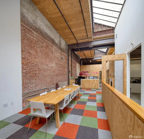 a view of a balcony with chair and wooden floor