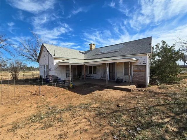 a view of a house with a yard covered in snow