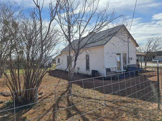 a backyard of a house with shaded area