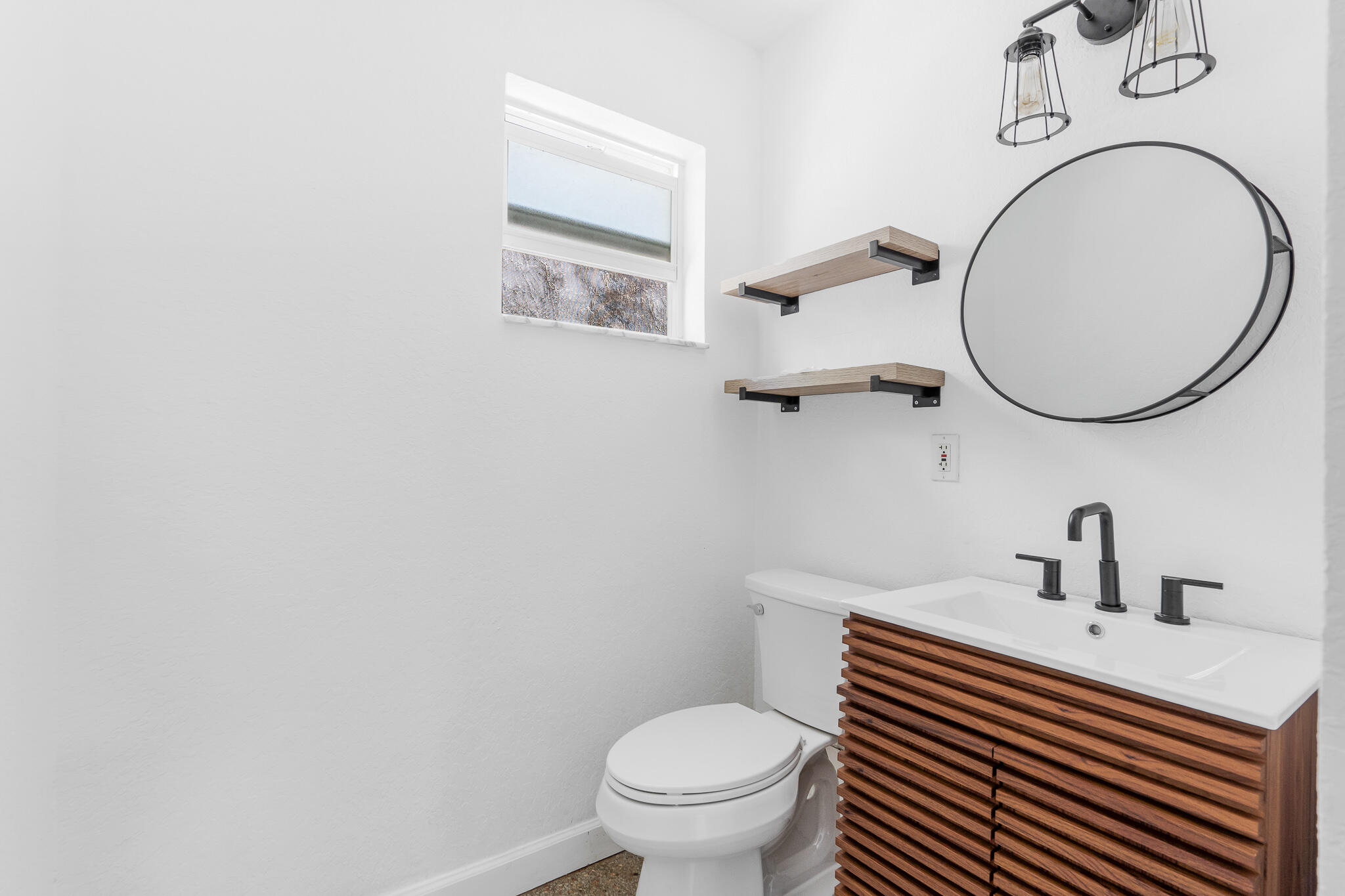 11 Tropical Drive, Unit 3 Ocean Ridge, FL 33435 - Photo 13 of 15 a bathroom with a sink a toilet and a mirror