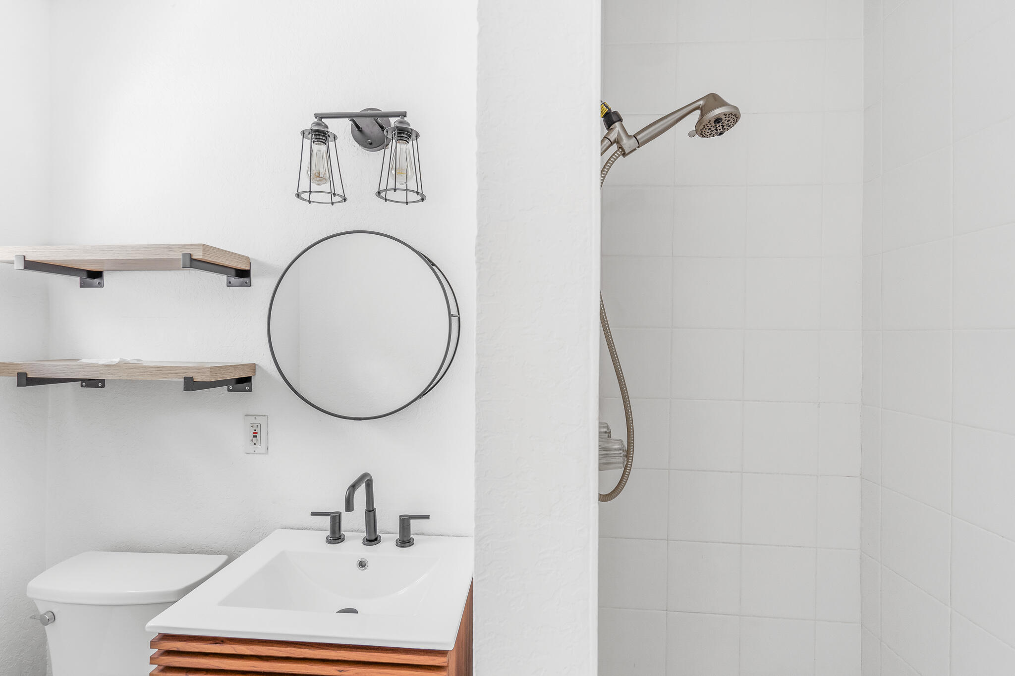 11 Tropical Drive, Unit 3 Ocean Ridge, FL 33435 - Photo 14 of 15 a bathroom with a toilet sink and mirror