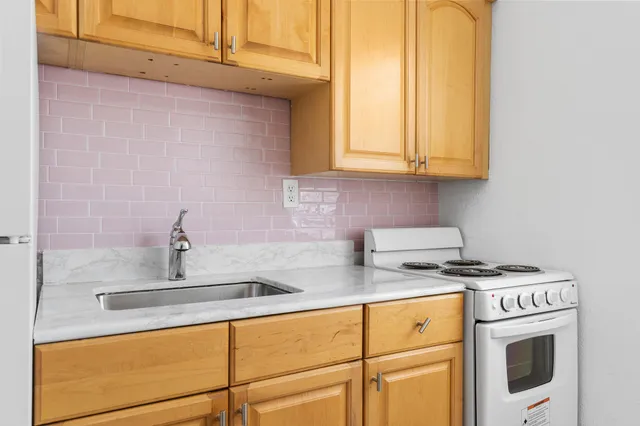 a kitchen with stainless steel appliances granite countertop a sink stove and cabinets