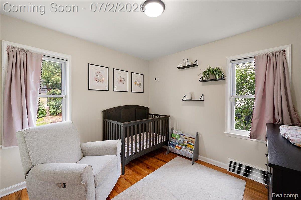 1706 Princeton Road Berkley, MI 48072 - Photo 29 of 49 Bright room featuring two large windows, wood-finish flooring, a neutral wall color, and a flush-mount ceiling light fixture