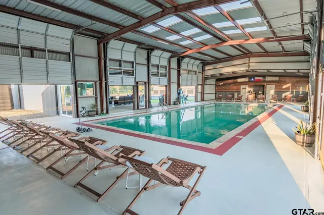 a view of swimming pool with lounge chair