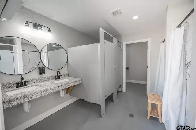 a bathroom with a toilet and a shower