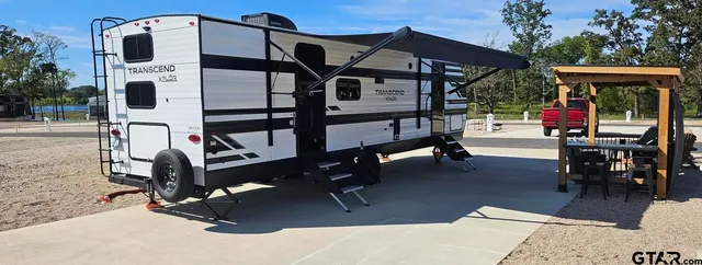 a view of a roof deck with furniture