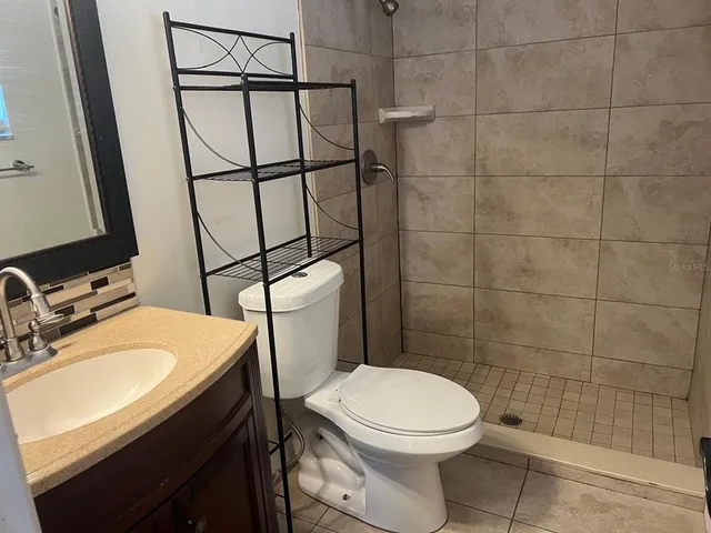 a bathroom with a sink toilet and shower