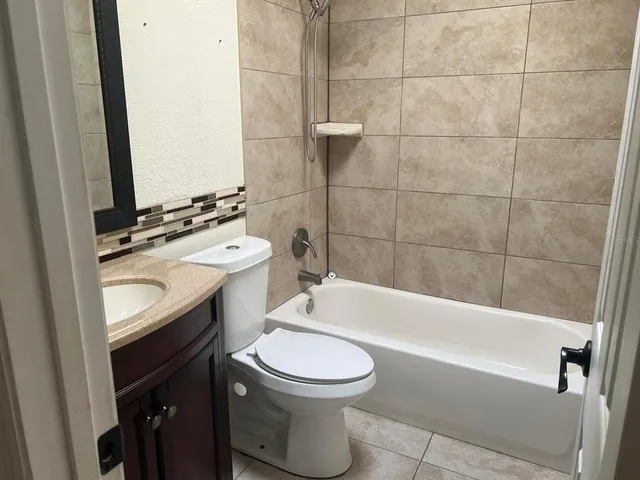 a bathroom with a sink a toilet and bathtub