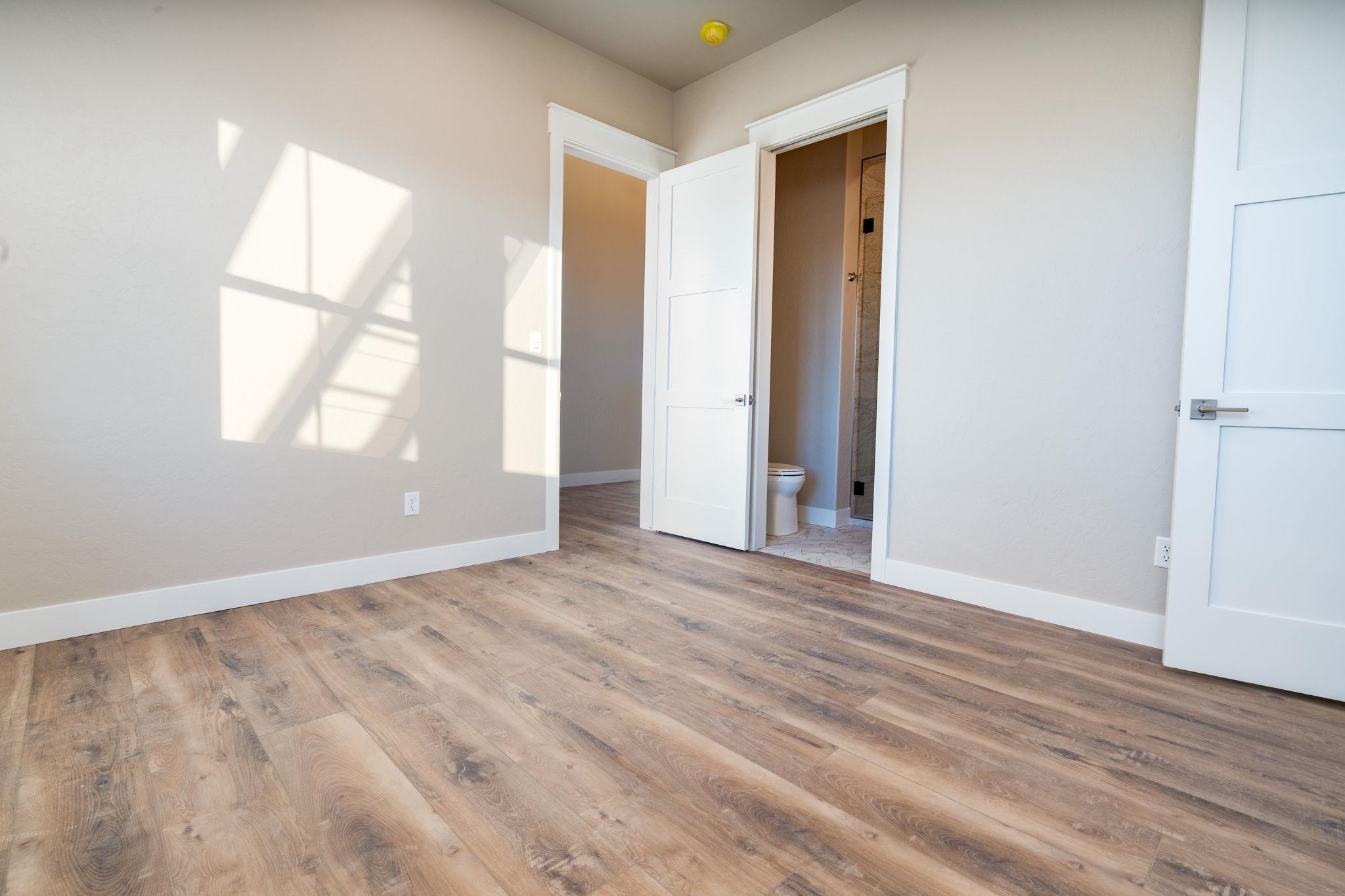 1928 K Road Fruita, CO 81521 - Photo 11 of 32 an empty room with wooden floor and windows