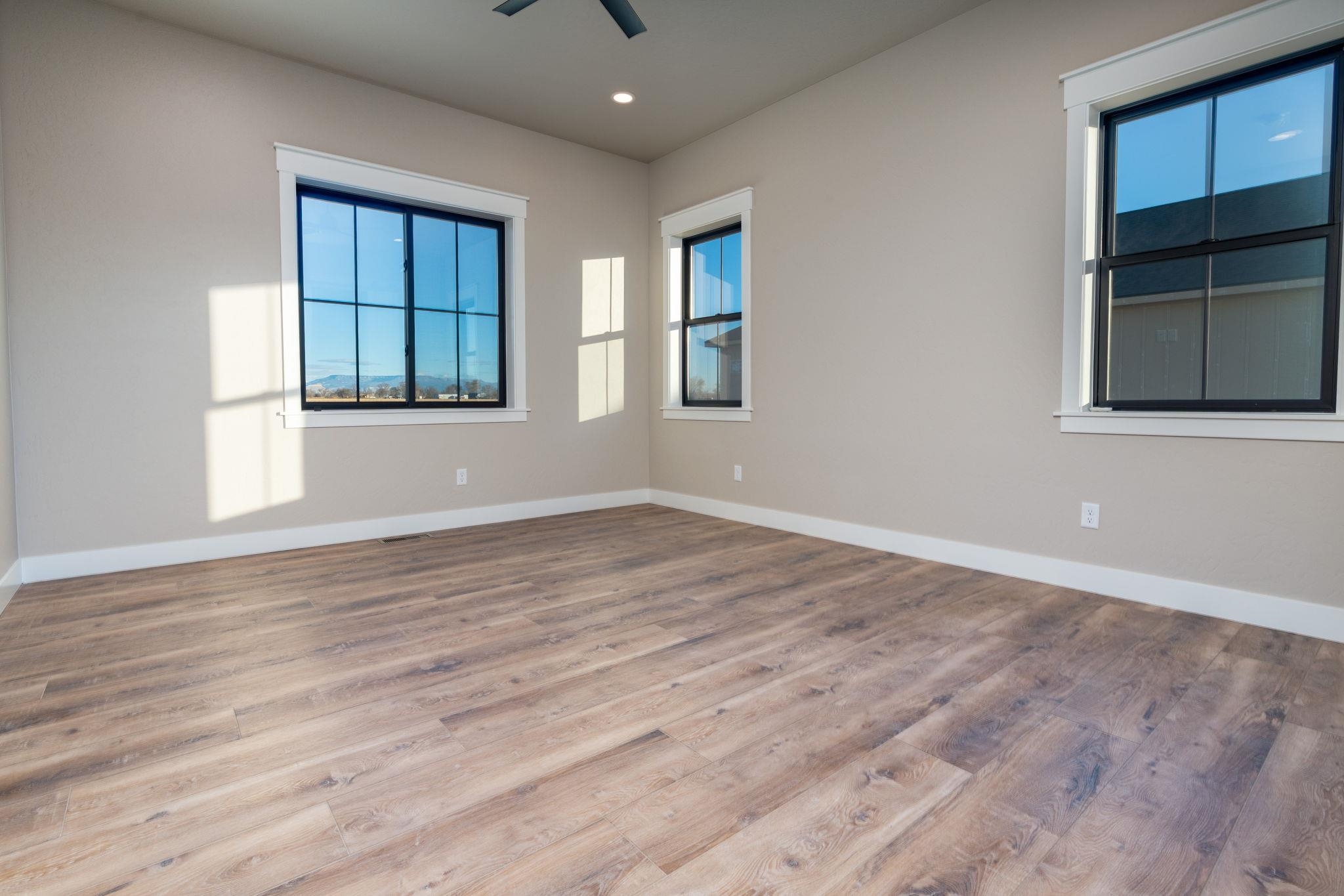 1928 K Road Fruita, CO 81521 - Photo 13 of 32 a view of empty room with wooden floor and fan