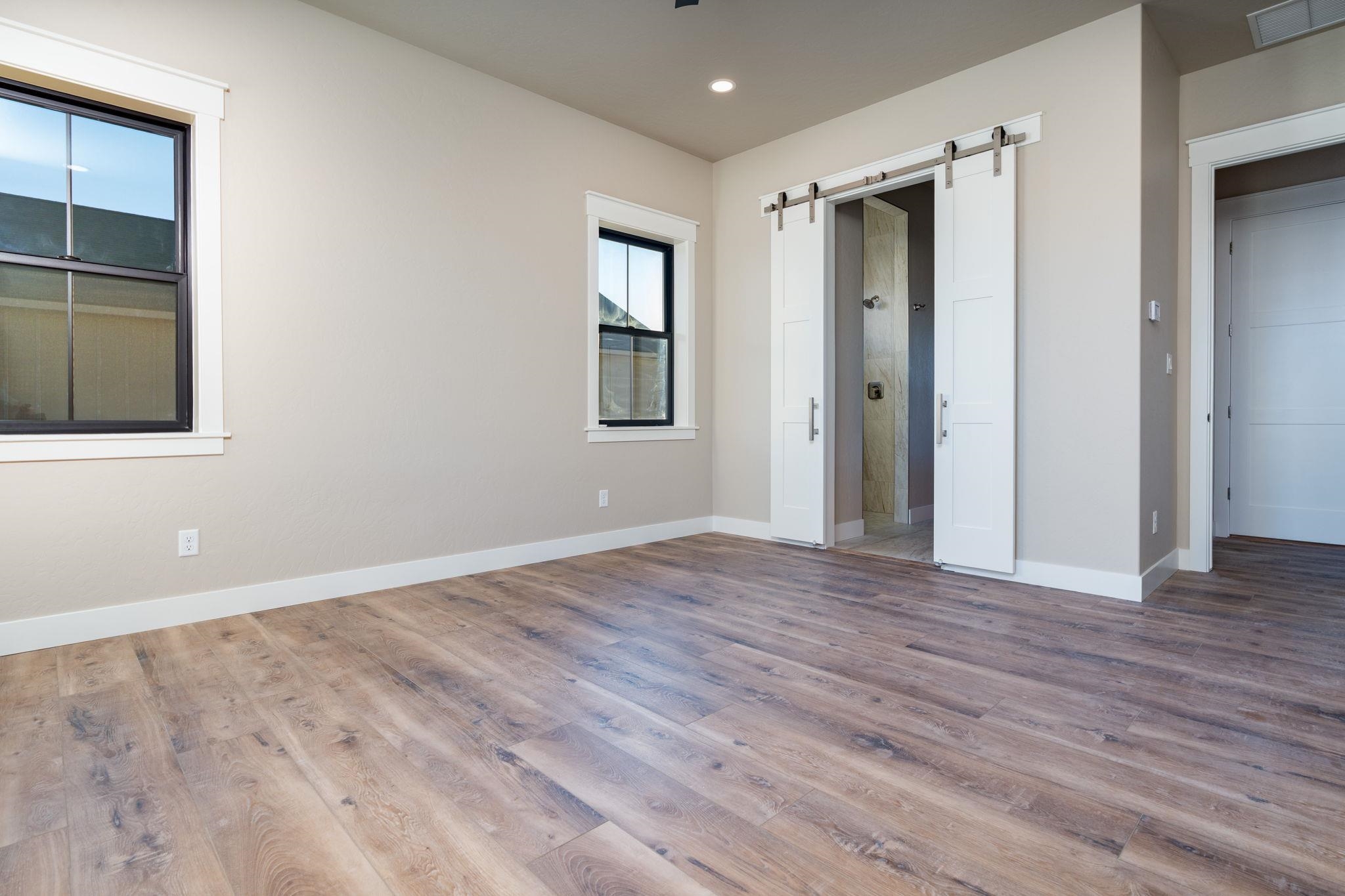 1928 K Road Fruita, CO 81521 - Photo 14 of 32 a view of an empty room with wooden floor and a window