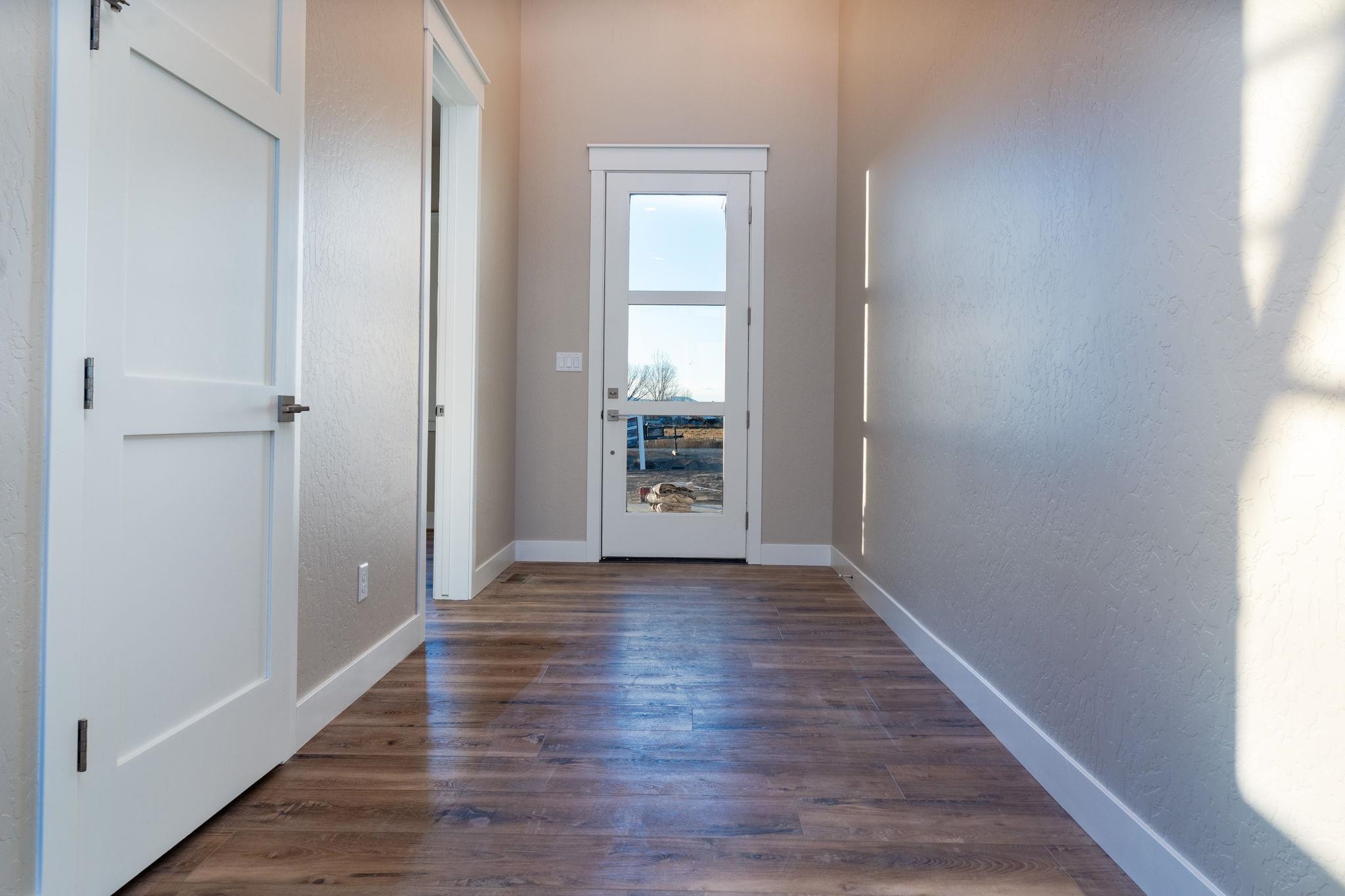1928 K Road Fruita, CO 81521 - Photo 19 of 32 a view of an empty room with wooden floor and a window