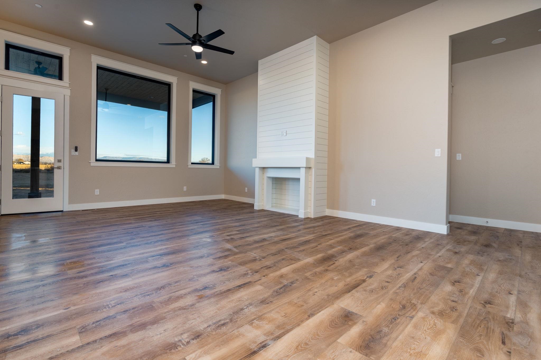 1928 K Road Fruita, CO 81521 - Photo 22 of 32 a view of an empty room with window and wooden floor