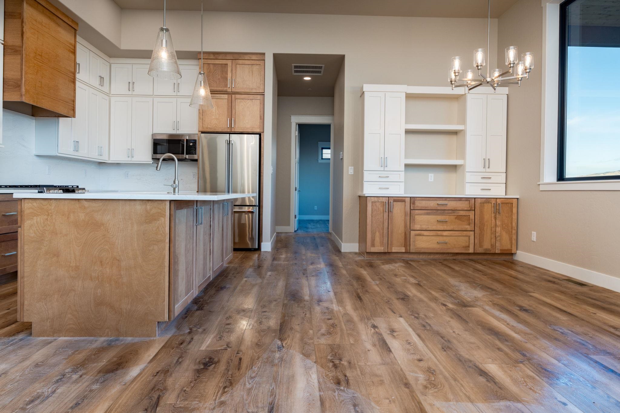 1928 K Road Fruita, CO 81521 - Photo 24 of 32 a view of a kitchen with cabinets and wooden floor