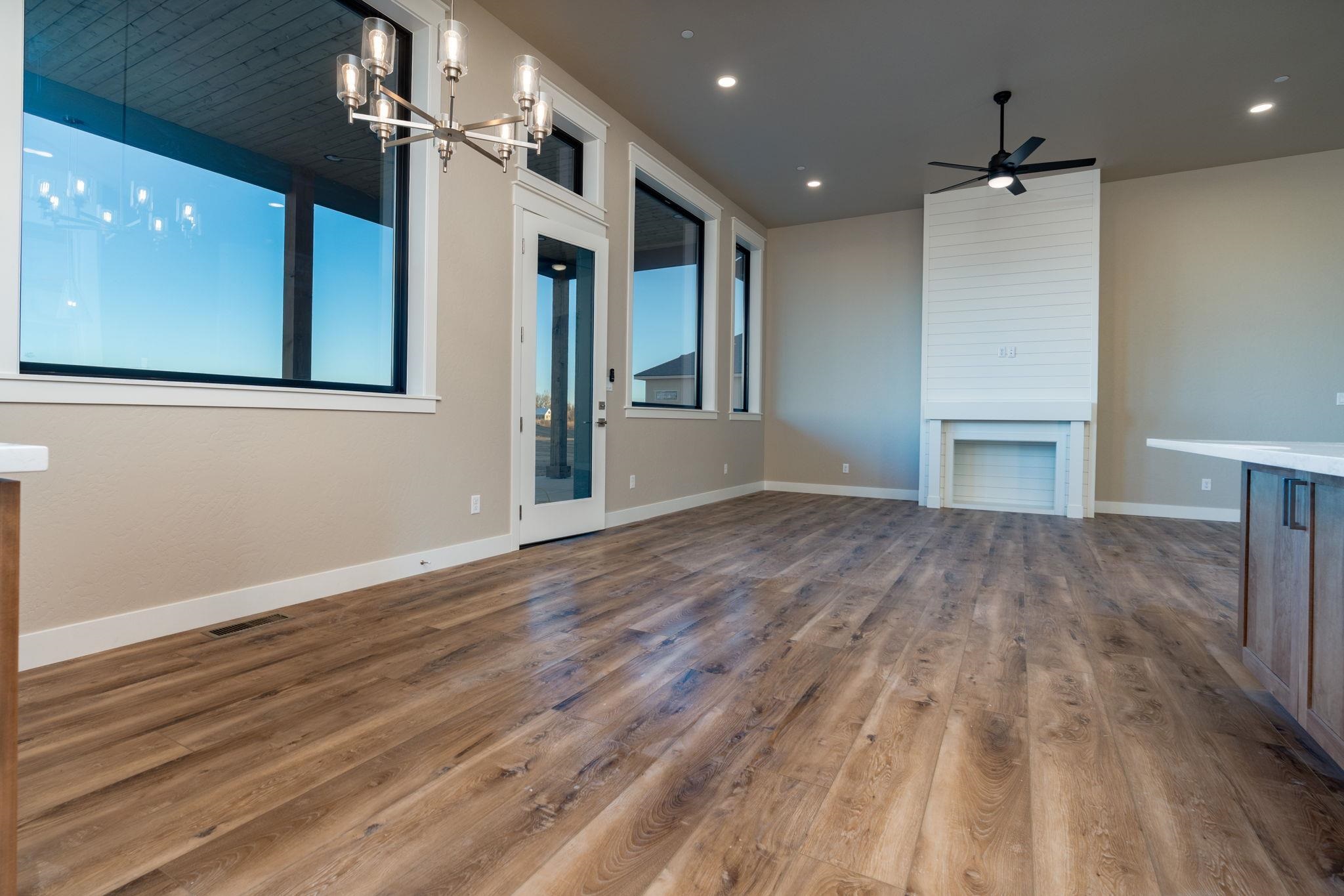1928 K Road Fruita, CO 81521 - Photo 25 of 32 a view of an empty room with wooden floor and a kitchen