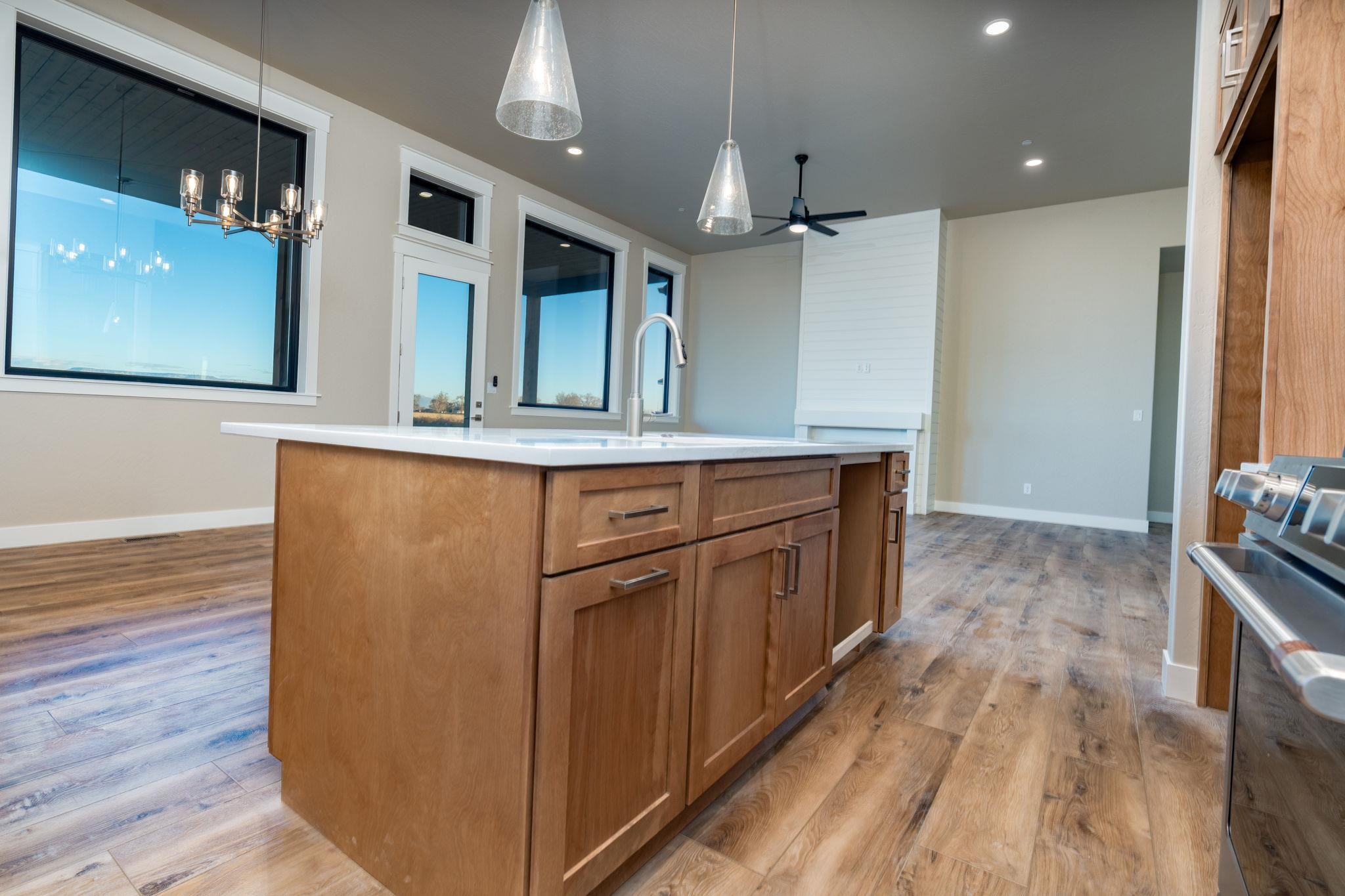 1928 K Road Fruita, CO 81521 - Photo 27 of 32 a kitchen with kitchen island a counter top space a sink stainless steel appliances and cabinets