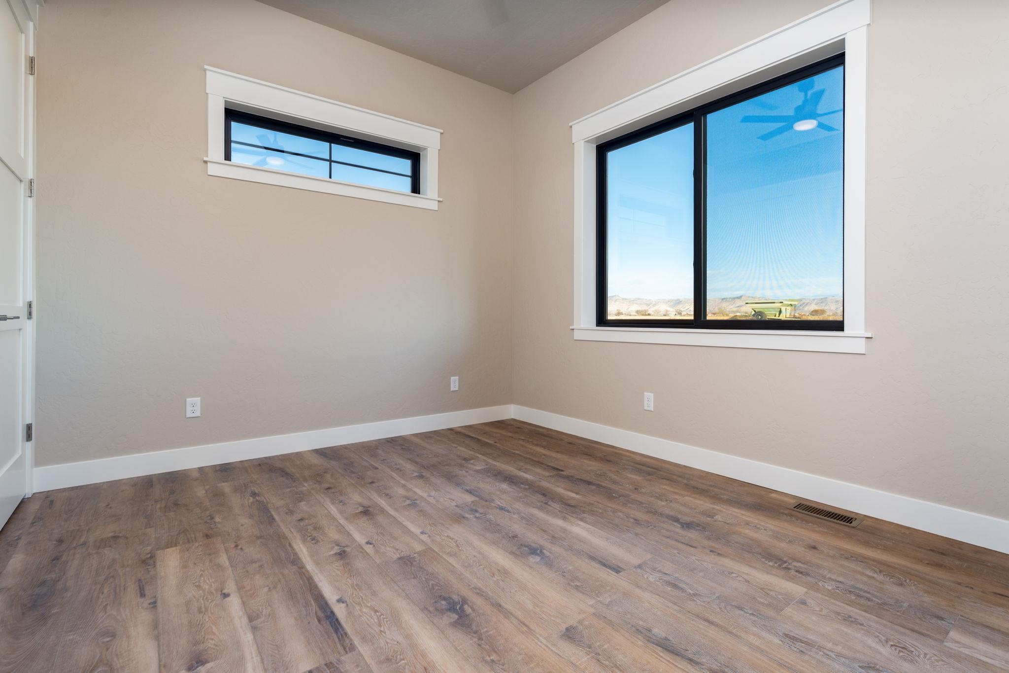 1928 K Road Fruita, CO 81521 - Photo 28 of 32 a view of an empty room with wooden floor and a window