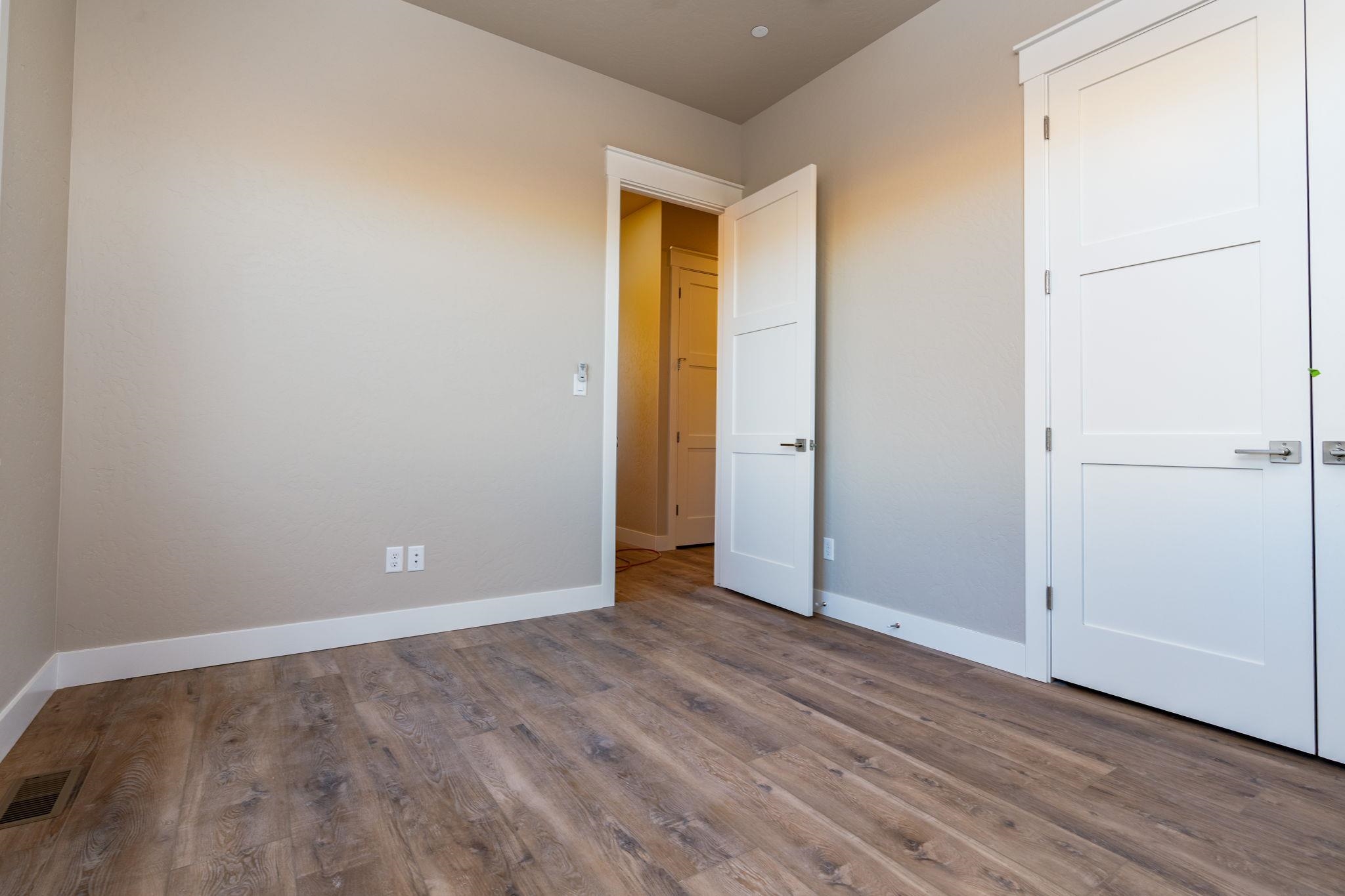 1928 K Road Fruita, CO 81521 - Photo 6 of 32 a view of an empty room with wooden floor and closet