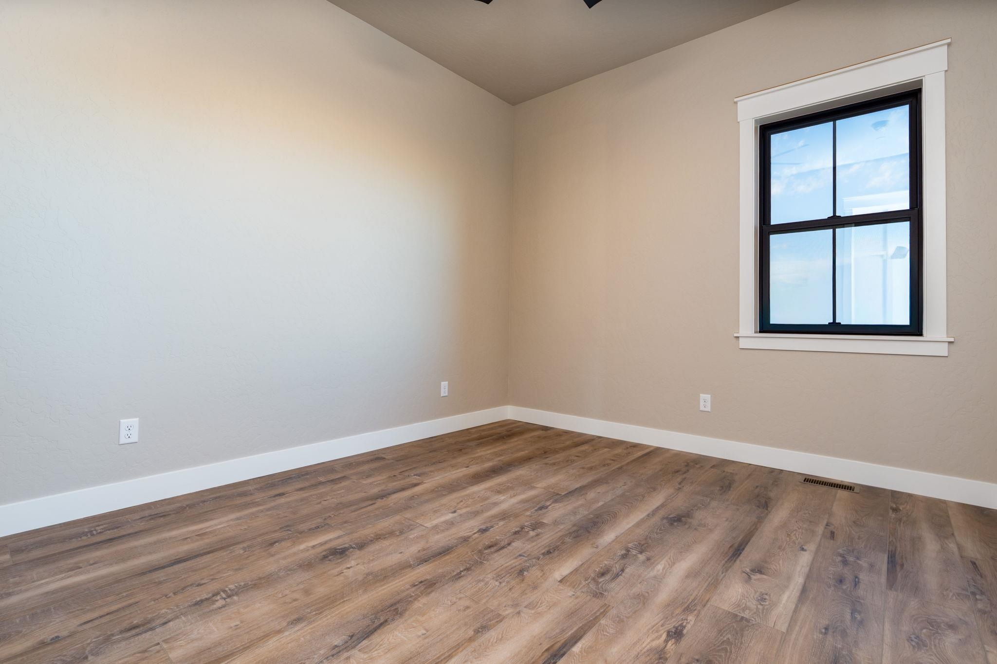 1928 K Road Fruita, CO 81521 - Photo 8 of 32 an empty room with wooden floor and windows