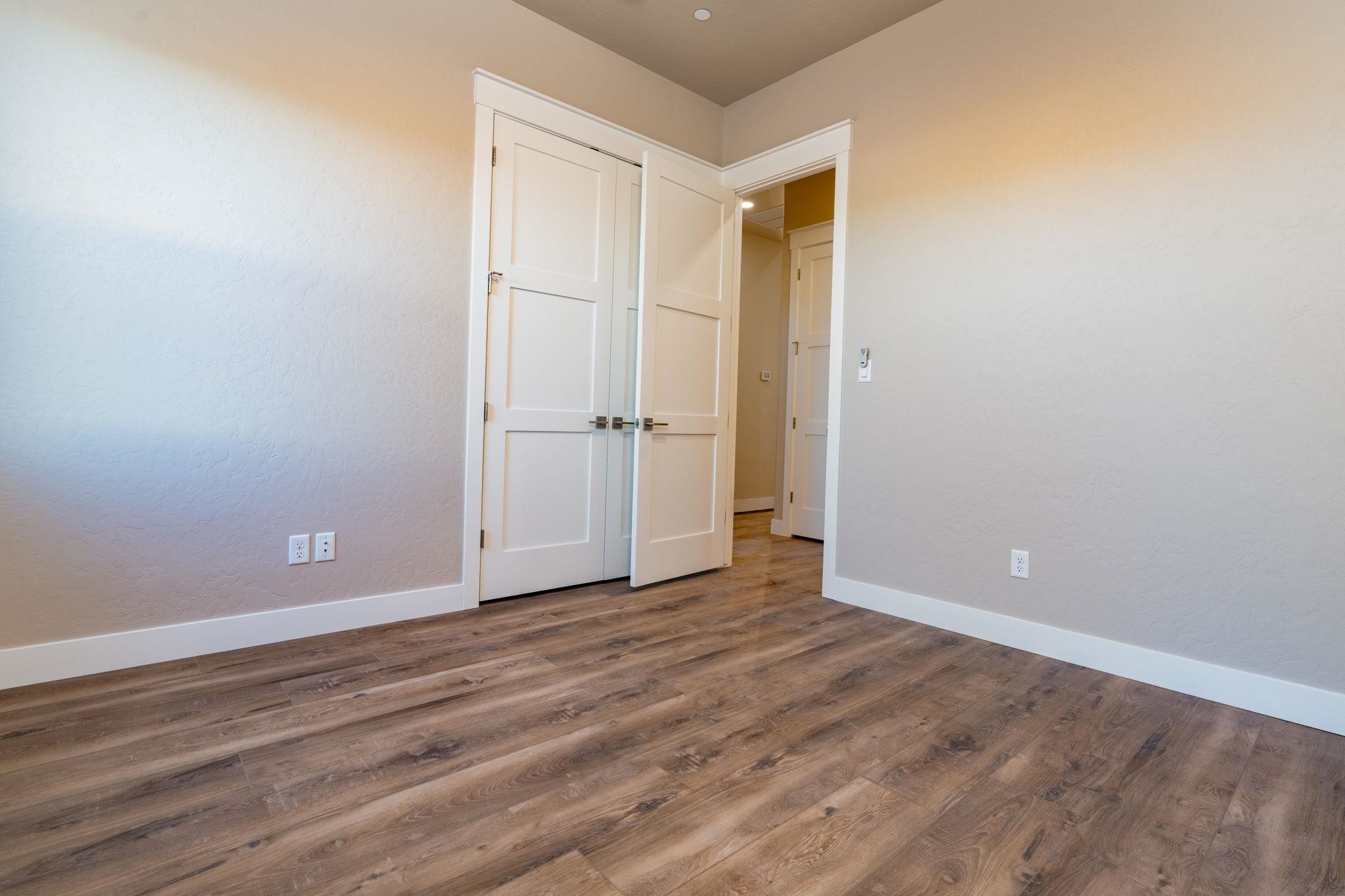 1928 K Road Fruita, CO 81521 - Photo 9 of 32 a view of an empty room with wooden floor