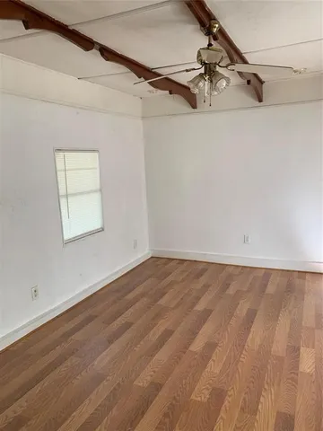 a view of a room with wooden floor and shower