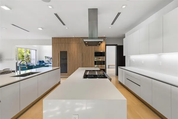 a dining room filled chandelier and a wooden floor