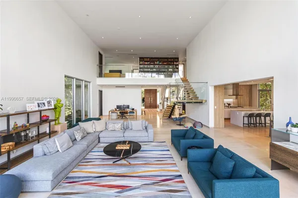 a living room with lots of furniture and a book shelf