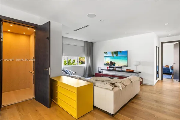 a bedroom with furniture and a large window