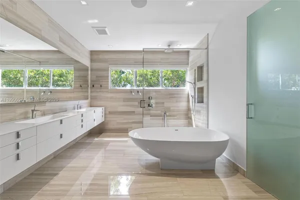 a room with furniture a rug and white walls