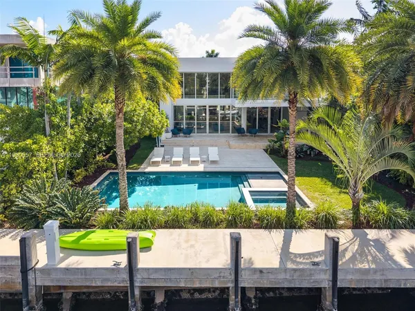 a view of a building with a garden and sitting area