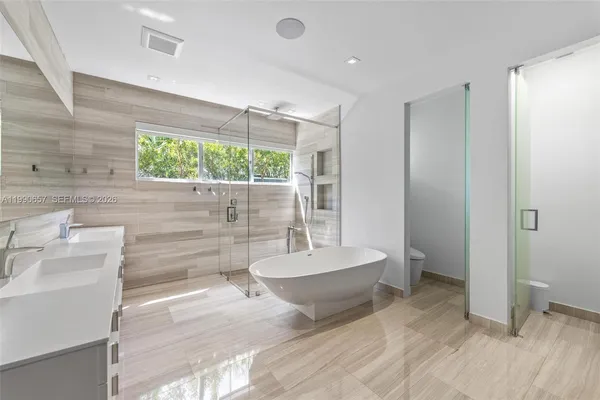 a bathroom with a sink a toilet and bathtub