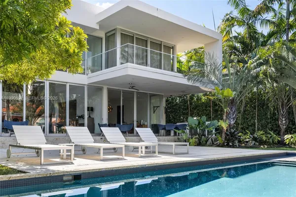 a view of a swimming pool with a table and chairs