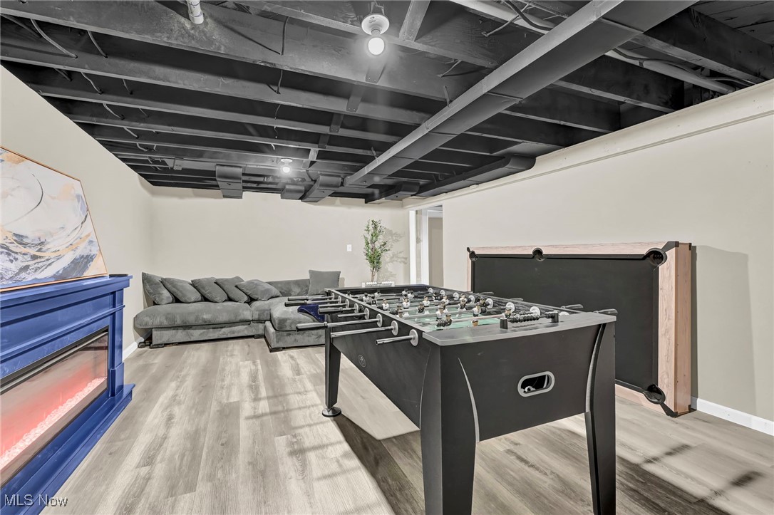 1731 Berger Road Akron, OH 44312 - Photo 29 of 37 Game room with an electric fireplace and light wood-style floors