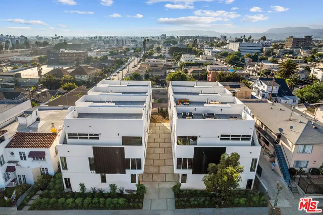 an aerial view of residential houses with outdoor space