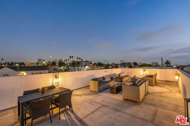 a terrace with outdoor seating and city view