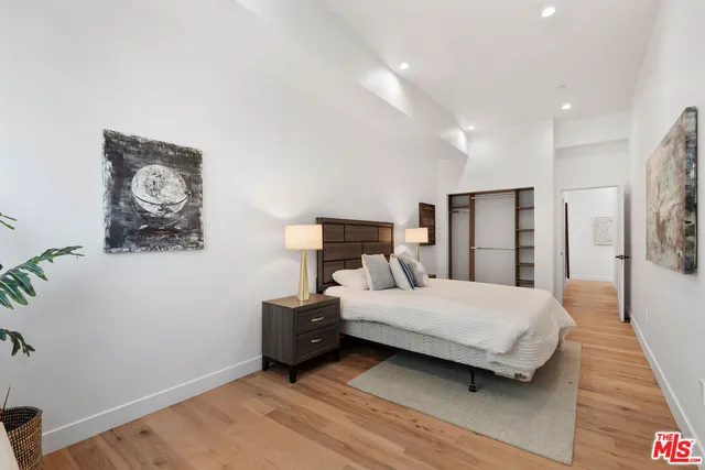 a bedroom with a bed and a lamp