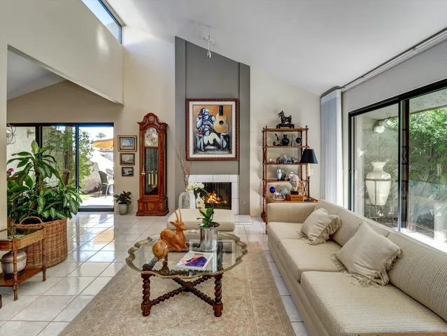 a living room with furniture fireplace and flat screen tv