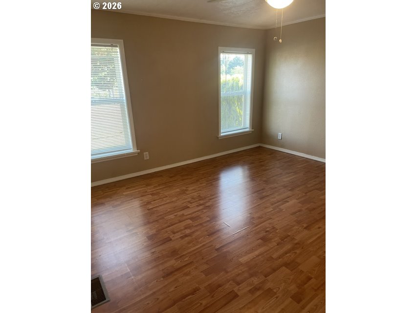 5660 Daisy Street, Unit 31 Springfield, OR 97478 - Photo 20 of 44 a view of an empty room with wooden floor and a window