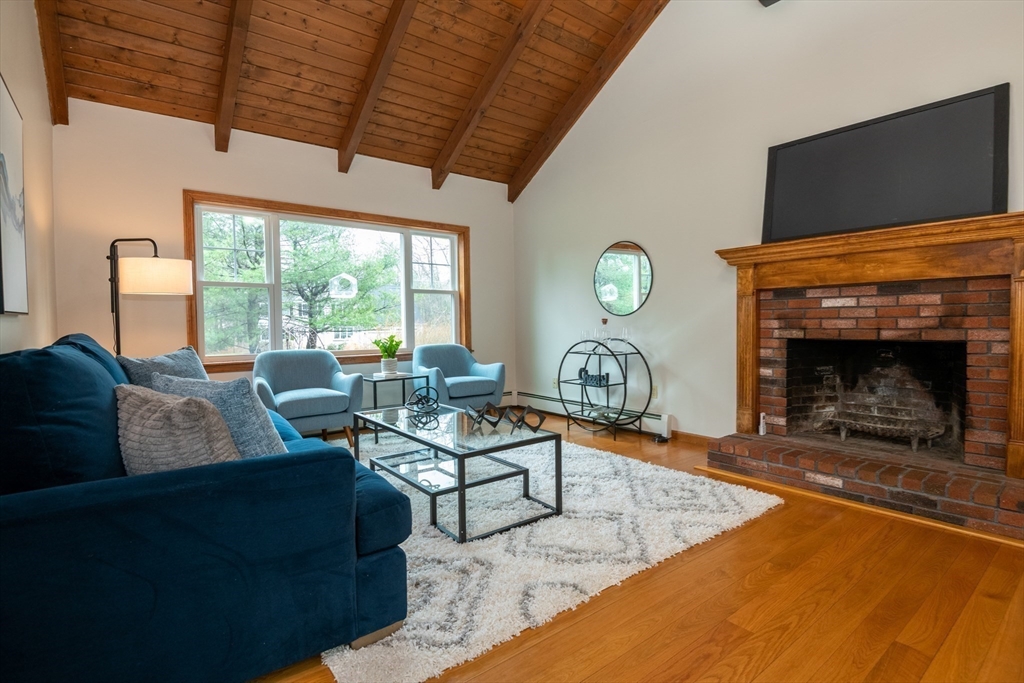 159 Willow Street Acton, MA 01720 - Photo 11 of 34 a living room with fireplace furniture and a flat screen tv