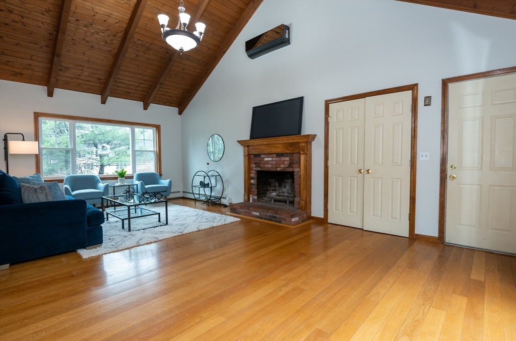 159 Willow Street Acton, MA 01720 - Photo 13 of 34 a living room with furniture and a fireplace