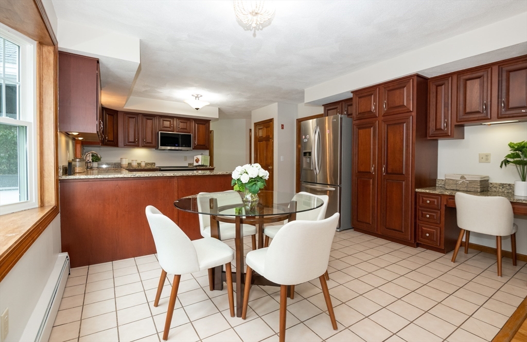 159 Willow Street Acton, MA 01720 - Photo 14 of 34 a dining room with furniture a window and kitchen view