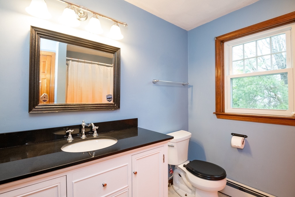 159 Willow Street Acton, MA 01720 - Photo 21 of 34 a bathroom with a granite countertop sink vanity mirror and toilet