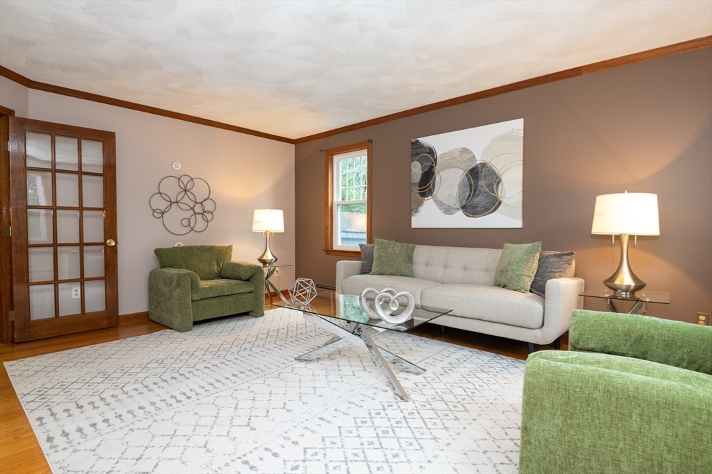 159 Willow Street Acton, MA 01720 - Photo 5 of 34 a living room with furniture and a painting on the wall