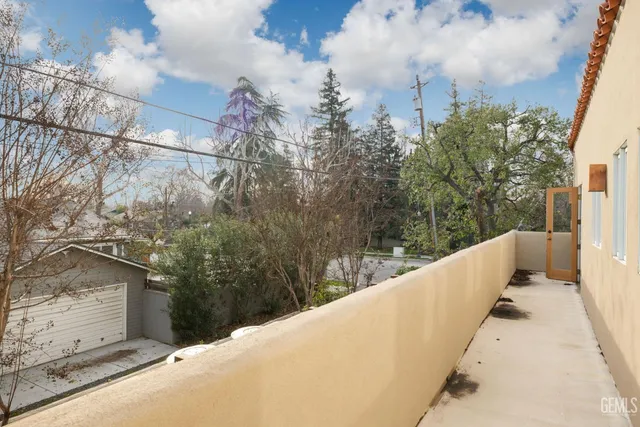 an aerial view of a house with a yard and large trees