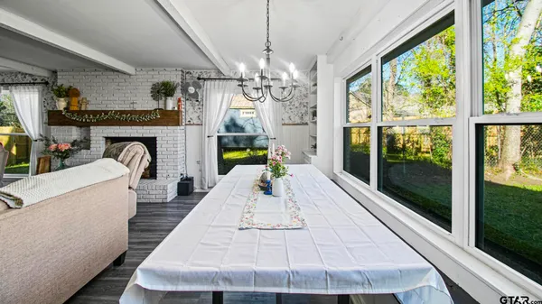 a living room with fireplace furniture and a chandelier