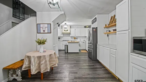 a kitchen with cabinets and wooden floor