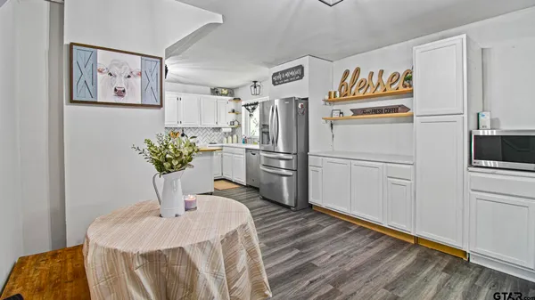 a kitchen with stainless steel appliances a refrigerator and a stove
