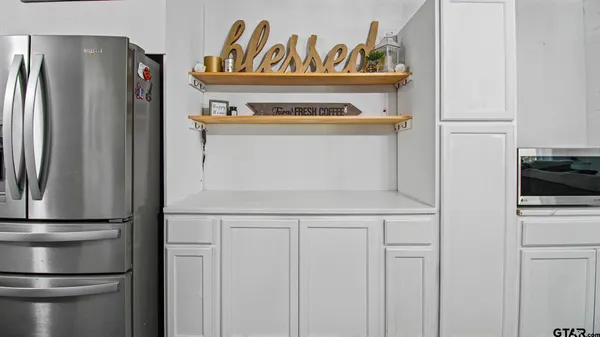 a kitchen with stainless steel appliances a refrigerator and a stove