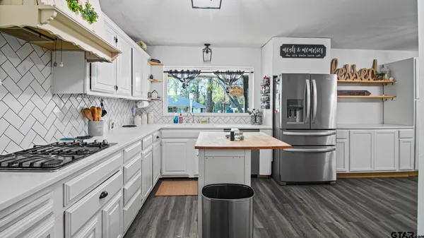 a kitchen with stainless steel appliances a sink stove and refrigerator